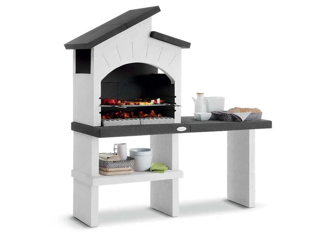 Barbecue à bois et charbon Palazzetti Ravello en ciment réfractaire avec grille réglable 68 x 40 cm, espaces de rangement et finitions Marmotech. Idéal pour 10 à 14 personnes.